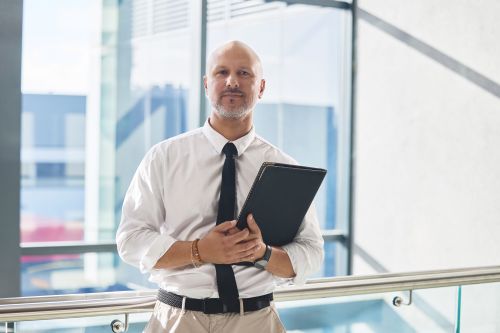 IP lawyer standing in modern sunlit building with documents